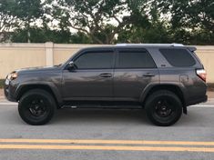 a gray toyota 4runner is parked in a parking lot