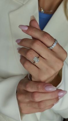 a woman's hand with two rings on it