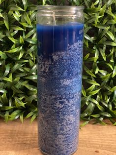 a blue candle sitting on top of a wooden table