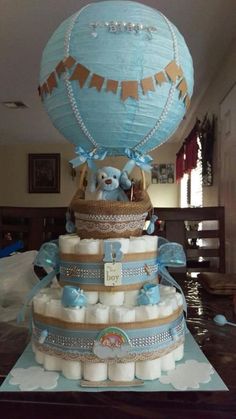 a cake made to look like a hot air balloon with diapers around it and teddy bears on top