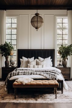 a large bed sitting in a bedroom next to two planters on either side of the bed