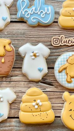 baby shower cookies are arranged on a wooden table