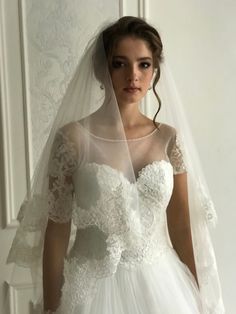 a woman wearing a wedding dress and veil