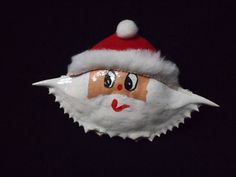 a paper mache with a santa claus hat on it's head and eyes