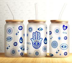 three mason jars decorated with blue and white designs