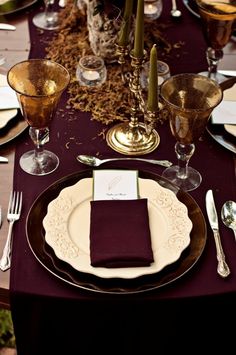 the table is set with place settings and silverware