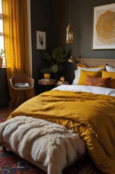 a bed with yellow sheets and pillows in a bedroom next to a chair, table and potted plant