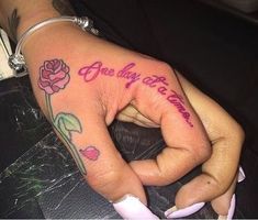 a person with a tattoo on their hand that says, one day at a time