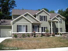 a large gray house with lots of windows