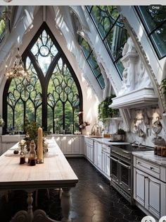 a large kitchen with an arched window and wooden table in front of the countertop