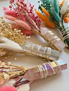 several different types of flowers and feathers on a table