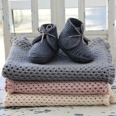 a pile of blankets and shoes sitting on top of each other