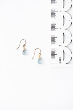 A beautiful gift for those born in March, featuring their birthstone of a stunning hand wrapped aquamarine briolette. These feminine earrings dangle at 1" from gold filled ear wires. Gold Filled (lead and nickel free) Aquamarine 1", on gold filled ear wires We hand select our natural materials, thus there may be slight variations in color and/or size that will not detract from the overall aesthetic Our unique handcrafted designer jewelry for women is made in America, with each design created ind Gold Aquamarine Teardrop Jewelry, 14k Gold Filled Teardrop Earrings For Gift, Teardrop Blue Topaz Birthstone Earrings, Blue Topaz Teardrop Birthstone Earrings, 14k Gold Filled Birthstone Teardrop Earrings, Teardrop Jewelry With French Hook For Gifts, Adjustable Teardrop Jewelry With French Hook, Teardrop French Hook Jewelry As A Gift, Teardrop French Hook Jewelry For Gifts