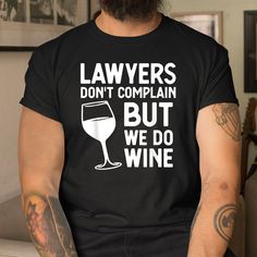 a man wearing a black t - shirt that says, lawers don't complain but we do wine