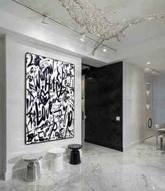 a white room with black and white artwork on the wall