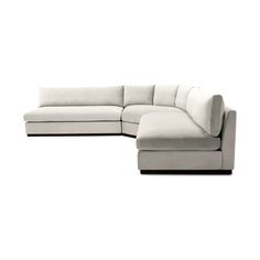 a white sectional couch sitting on top of a white floor