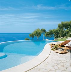 an empty swimming pool next to the ocean