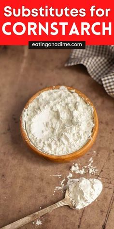 a wooden spoon filled with white powder next to a jar of cornstarch on a table