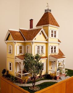 a doll house is shown on top of a table