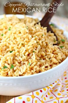 a white bowl filled with rice on top of a wooden table