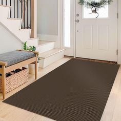 a brown area rug in front of a white door