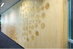 an office wall with wood carvings on the side and glass doors to the other side