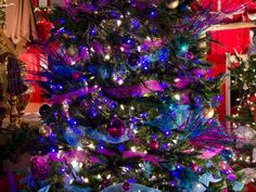 a decorated christmas tree with purple and blue lights