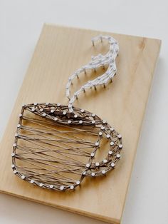 a wooden board with some wire wrapped around it