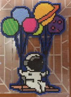 an image of a cross stitch card with balloons and spaceman on it's back