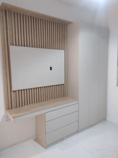 an empty room with white walls and wooden slats on the wall, as well as a large mirror