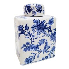 a blue and white vase with flowers on the lid is sitting in front of a white background