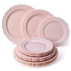 pink dinner plates stacked on top of each other