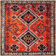 an orange rug with black and white designs on the bottom, in front of a white background