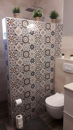 a bathroom with a toilet and tiled walls