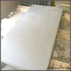 a large slab of concrete sitting on top of wooden pallets in a building under construction