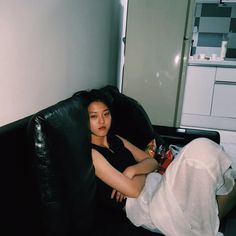 a woman sitting on a couch with her legs crossed