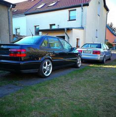 two cars parked next to each other in front of a house