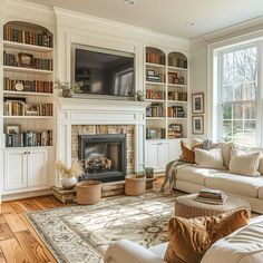 a living room filled with furniture and a fire place in front of a tv mounted on a wall