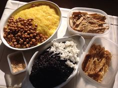 there are many different types of food in the dishes on the trays, including rice and beans