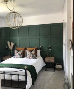 a bedroom with green walls and white bedding