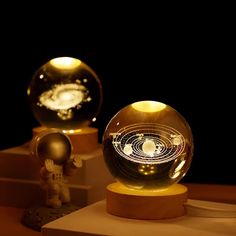 two glass globes sitting on top of wooden bases