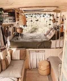 the inside of a small camper with lots of pillows