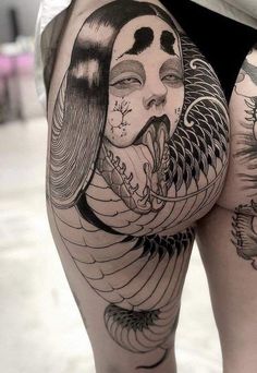 a woman's thigh with tattoos on it