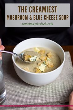 a person holding a spoon in a bowl of soup with cheese on top and the words, the creamiest mushroom & blue cheese soup