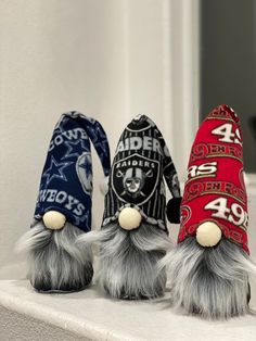 three hats are sitting on top of a shelf