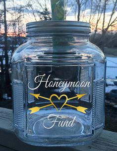 a glass jar with the words honeymoon fund on it