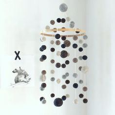 a mobile made out of rocks hanging from a wall