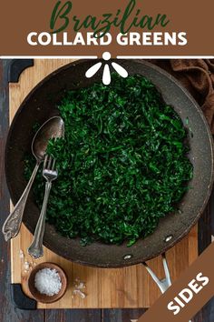 a pan filled with greens on top of a wooden cutting board next to spoons