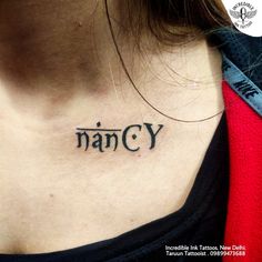 a woman's chest with the word nancy tattooed on it