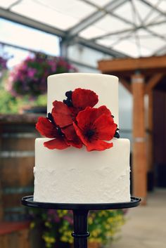 a white cake with red flowers on top